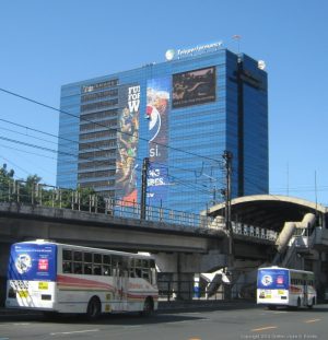 Alphaland Southgate Tower is a cuboid building covered primarily with blue glass panels and some billboards. This picture was taken while riding a bus approaching Chino Roces on the southbound side of EDSA.