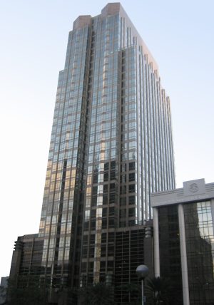 Ayala Life FGU Center - Makati is a bronze-colored building with an exterior covered by glass panels. It looks like two obelisks put side-by-side. This picture is seen from within the car park between Makati Sky Plaza and Jaka Tower on the opposite side of Ayala Ave.