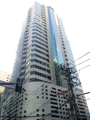 The concrete face of Chatham House's lower floors features open-air windows on the lower floors and glass exteriors on the middle and higher stories. This is Chatam House as seen from the opposite corner.