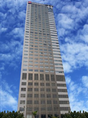 Cyberscape Beta as seen from ADB Avenue. It is a tall building with a concrete facade and windows forming a seven-column formation. The ground floor has entrances that are partly visible in this photograph.