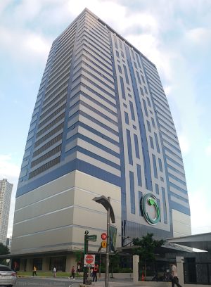 The Greenfield Tower is a tall blocky building with a facade made of blue glasses and gray concrete.