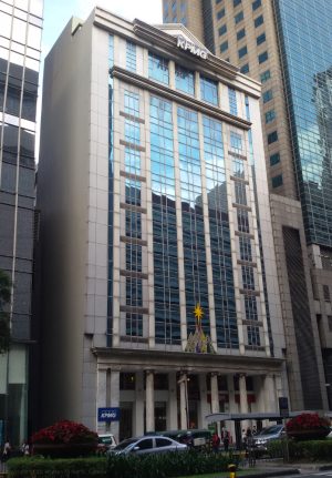 The KPMG Center is a white concrete structure with vertical glass panels across several floors and Greek columns at the ground floor.