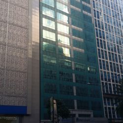 The MCC Center is a vertical, mid-rise building with a green glass and concrete facade.