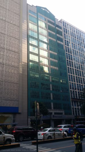 The MCC Center is a vertical, mid-rise building with a green glass and concrete facade.