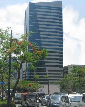On Global Place is a cuboid building with a facade divided into two sections by a diagonal border: one with alternating horizontal bands of glass and concrete and the other made of entirely glass panels. This is the view from the corner of 5th Ave. and 23rd St.
