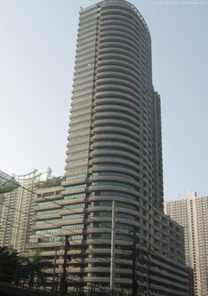 Paragon Plaza with curved architecture and horizontal line patterns. Shot from the EDSA southbound side while riding a bus passing by Petron station across Avida Towers Centera.