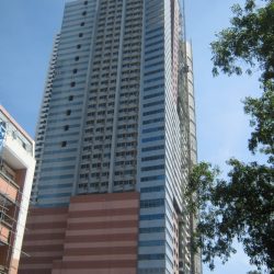 The image shows a blue building with several windows as seen from the island between the parallel service road at Roxas Blvd. across the gate of the United States Embassy.