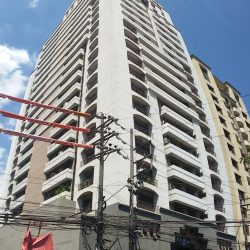 Picture of Platinum 2000 taken as vertical panorama on the opposite side of Annapolis St. within short walking distance west of Columbia St. The building has white facade with three balconies on each floor.