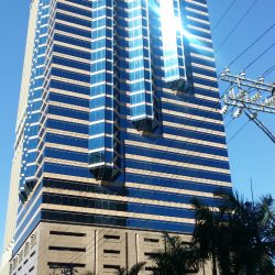 Union Bank Plaza is a bottle-like building with alternating bands of blue glass panels and beige concrete. This is the Union Bank Plaza, viewed from along Sapphire Road in front of Parc Chateau.