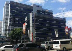 VRP medical center has a facade of white and gray horizontal steel bands. The picture here shows the view from across EDSA on the sidewalk in front of Paragon Plaza.