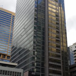 Wynsum Corporate Plaza is a tall and narrow rectangular prism covered with several panels of dark green glass. This picture was shot from the parking area between Prestige Tower and The Taipan Place.